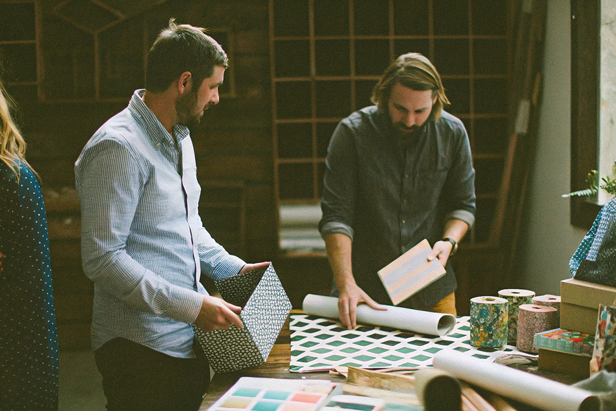 Small business owner with custom packaging products in a creative workspace