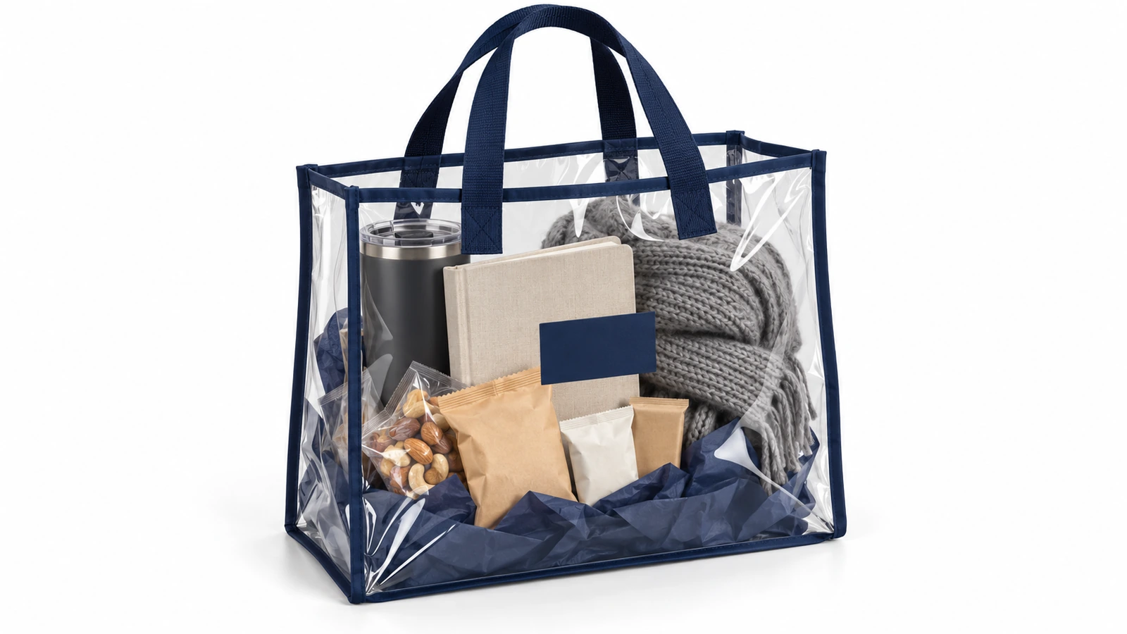 Transparente PVC-Tragetasche mit marineblauer Einfassung, gefüllt mit einem zusammengestellten Unternehmens-Geschenkset aus Trinkbecher, Notizbuch, Snacks und gefaltetem Schal, alles durch die Tasche sichtbar